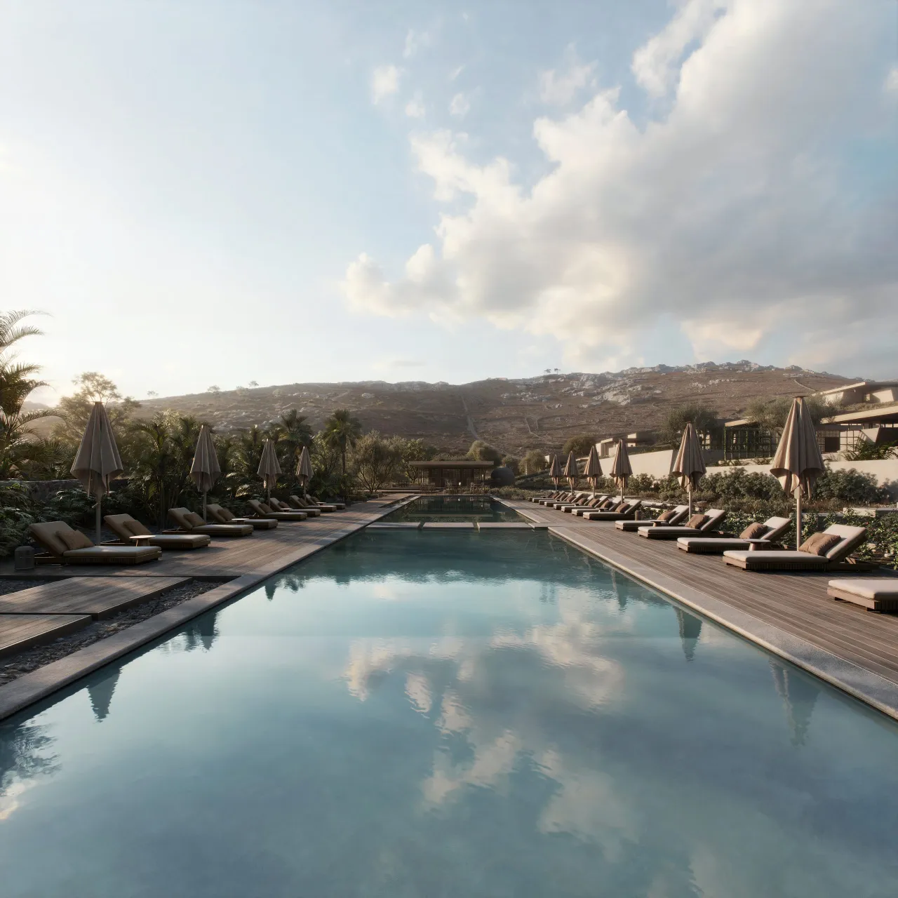 Rendering of a long resort pool with sun loungers and closed parasols, with low buildings on a bare mountain behind