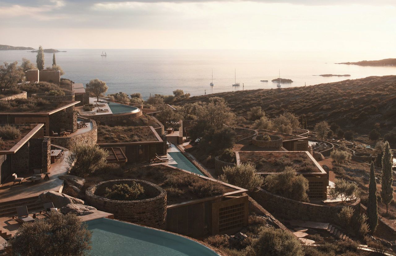 Shared Ground, Antiparos: guest houses with planted roofs and pools among olive trees on a hillside above the sea