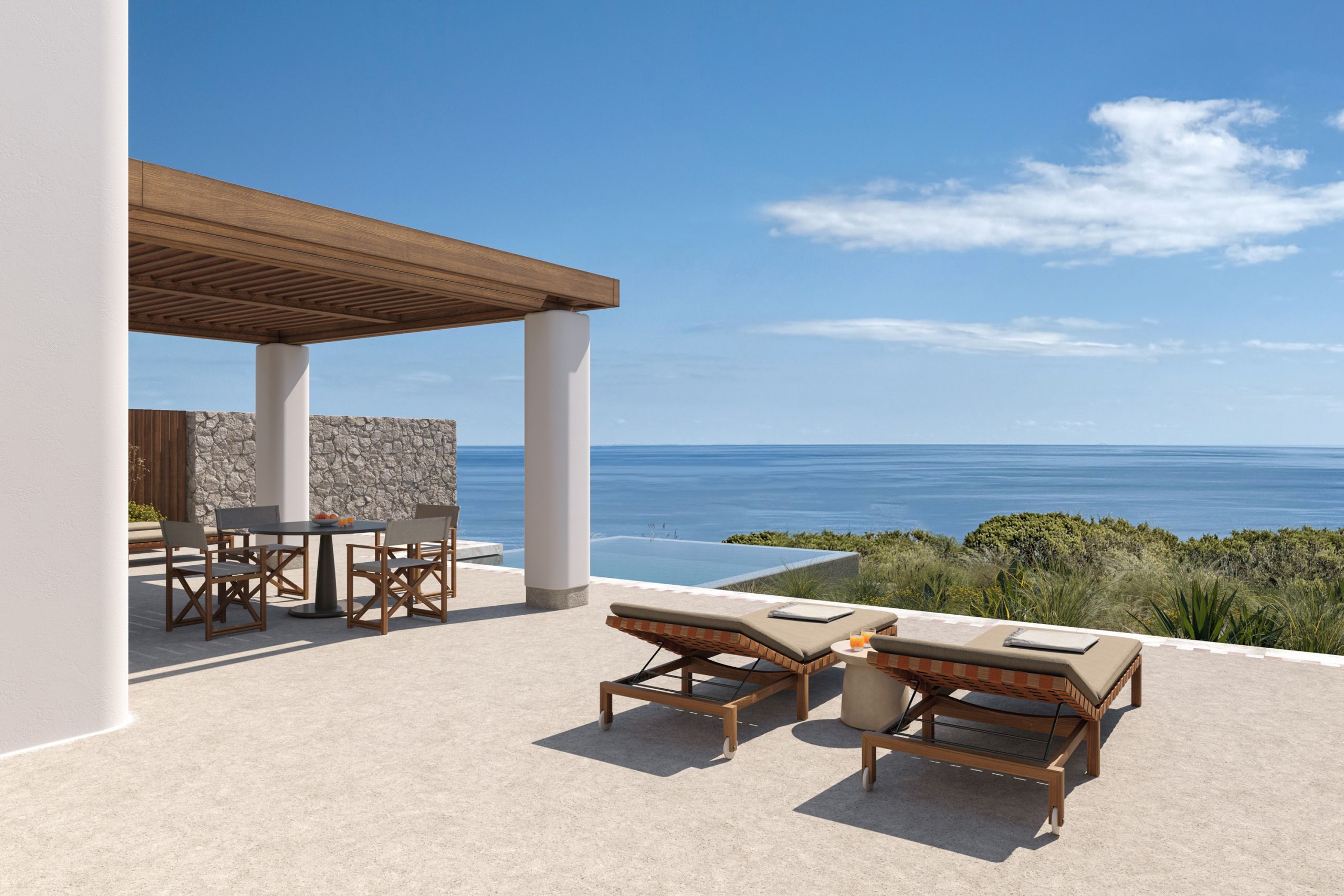 Terrace under a timber pergola with sun loungers and a dining table, looking out to the sea