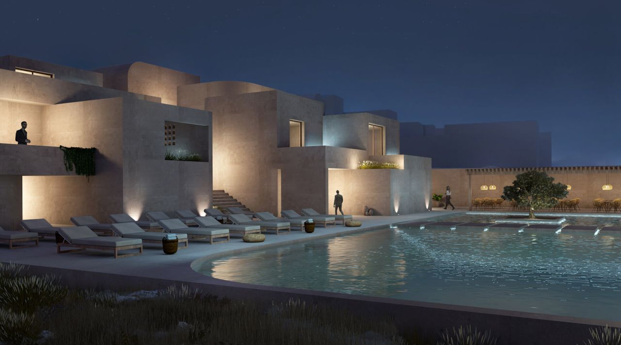 Rendering of Monolithic Village at night: sandy-toned cubic volumes, sun loungers and a curved pool lit under a starry sky