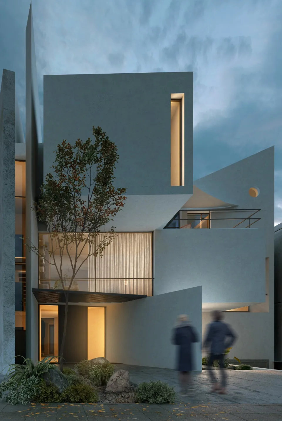 Residence in Nafplio: two people at the lit entrance of a white house with a tree in its courtyard, at dusk
