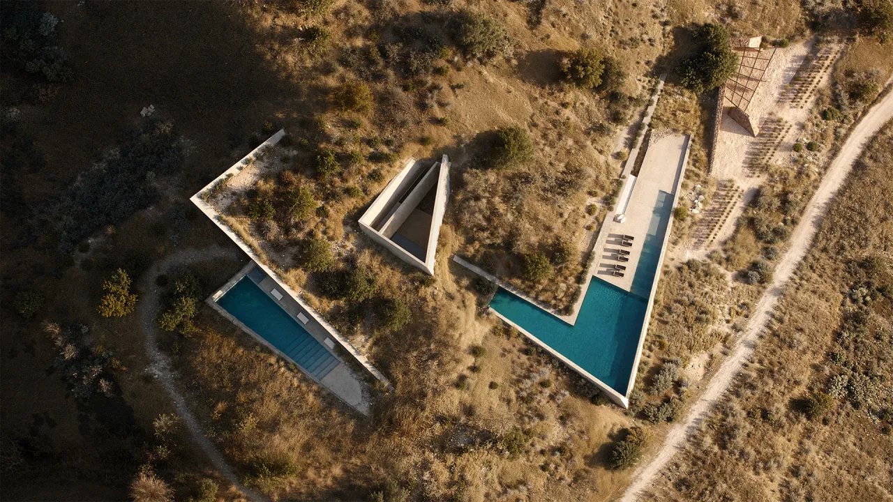 Rendering of Terra Fracta from directly above, angular concrete pools and a pavilion set into a dry hillside on Antiparos
